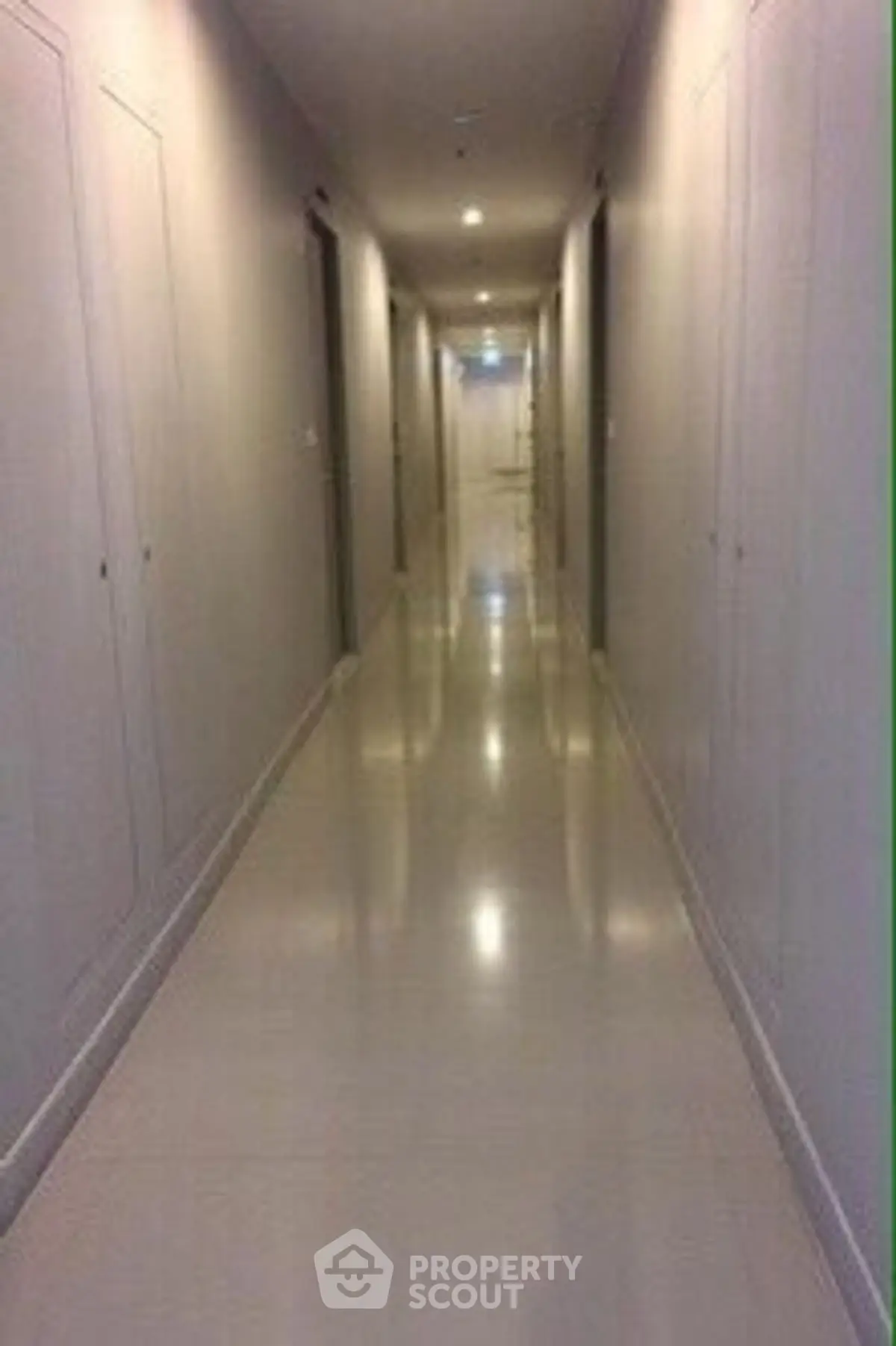Sleek modern hallway with polished floors and recessed lighting.