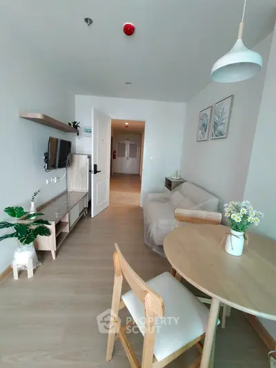 Charming modern living room with cozy decor and natural light, perfect for relaxation and entertaining.