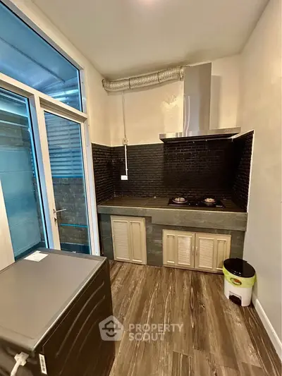 Modern kitchen with gas stove and sleek cabinetry in a compact layout