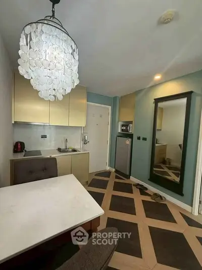 Modern kitchen with unique flooring and elegant chandelier