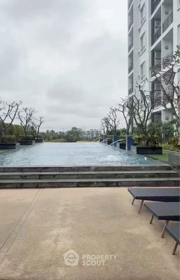 Luxurious apartment complex with stunning infinity pool and modern design.