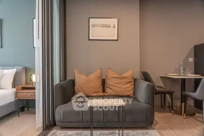 Modern living room with cozy sofa and dining area in stylish apartment.