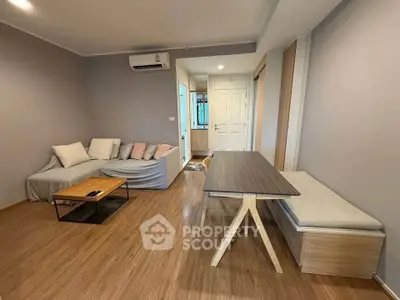 Spacious modern living room with stylish furniture and wooden flooring