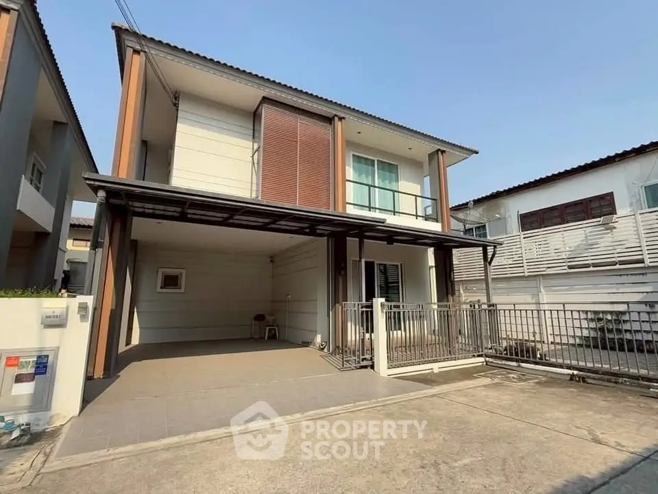 Modern two-story house with spacious driveway and contemporary design.