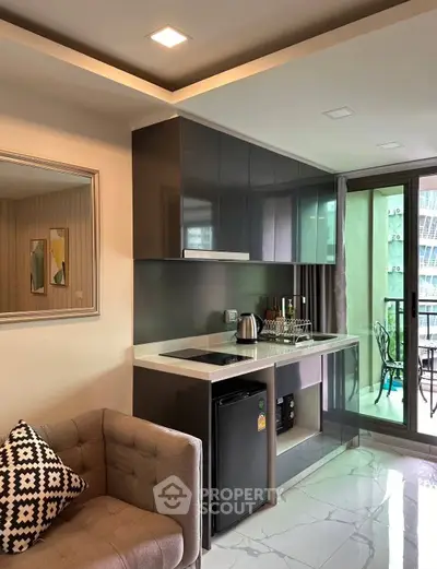 Modern kitchen with sleek cabinets and balcony view, perfect for urban living.