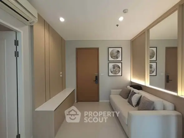 Modern living room with sleek design, cozy sofa, and stylish wall art in a contemporary apartment.