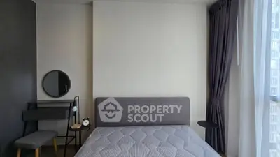 Modern bedroom with stylish decor and natural light, featuring a cozy bed and elegant furnishings.
