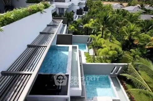 Luxurious multi-level pool area with lush greenery and modern architecture.