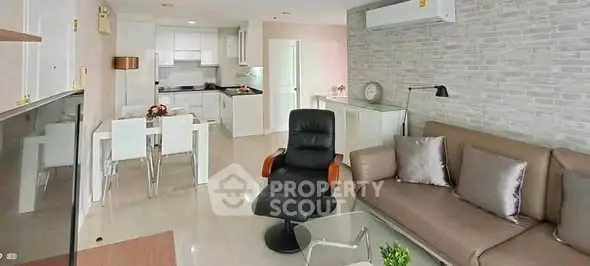 Modern living room with sleek furniture and open kitchen layout