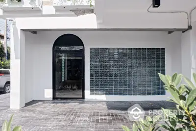 Modern building entrance with glass block wall and arched doorway