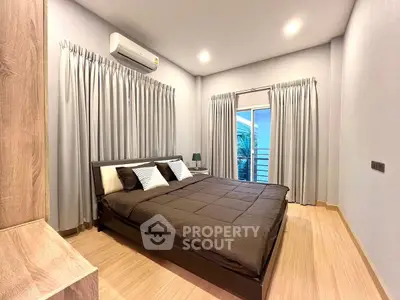 Modern bedroom with cozy decor and natural light, featuring a large bed and stylish curtains.