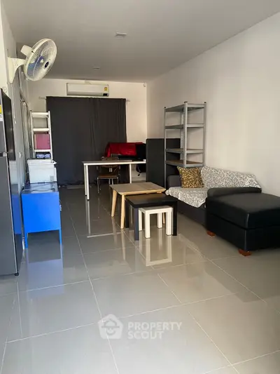 Spacious living room with modern furniture and tiled flooring