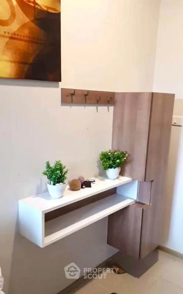 Modern entryway with sleek storage and decorative plants, perfect for stylish home organization.