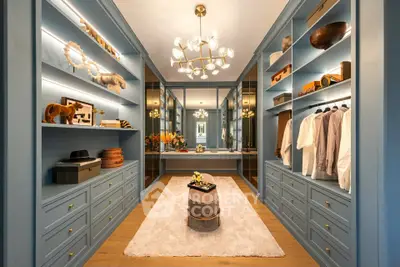 Luxurious walk-in closet with elegant lighting and ample storage space