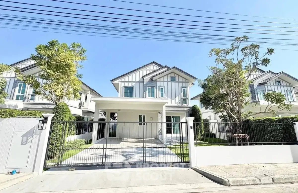 Charming modern house with spacious driveway and lush greenery in a serene neighborhood.