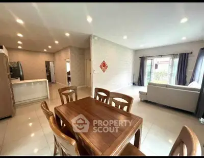 Spacious open-plan living room with dining area and modern kitchen in a bright, airy home.