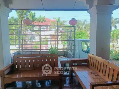 Charming outdoor seating area with wooden benches and lush greenery view