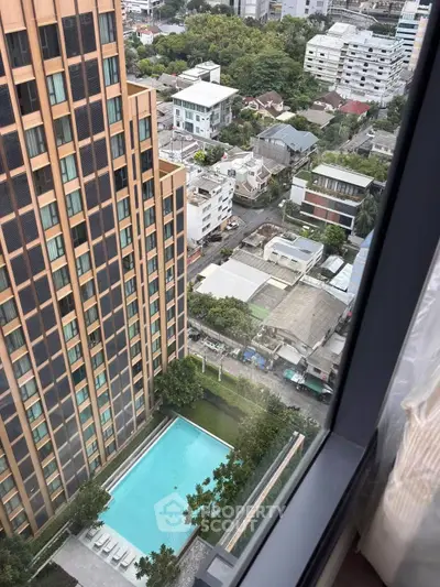 Stunning high-rise view with pool and cityscape, perfect for urban living.