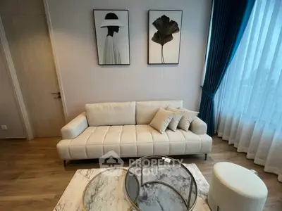 Stylish modern living room with elegant decor and large window view.