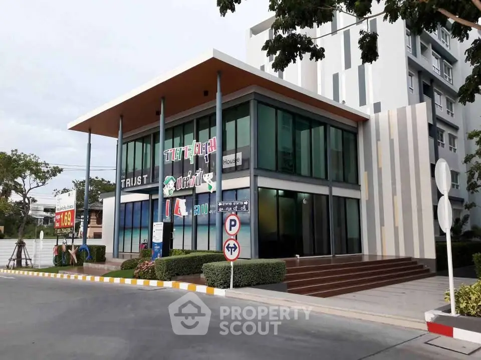 Modern commercial building with glass facade and signage, ideal for business opportunities.