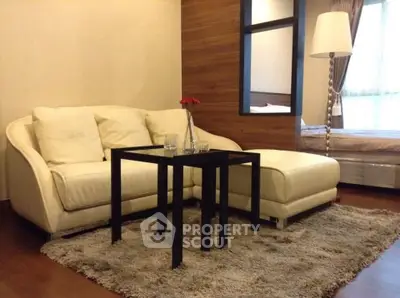 Cozy living room with plush sofa and modern decor in a stylish apartment.
