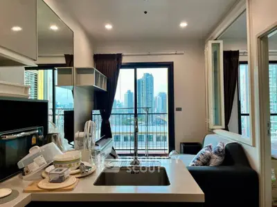 Modern kitchen with open layout and city view from balcony in high-rise apartment.