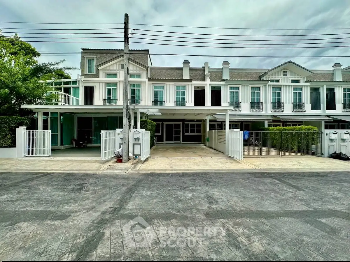 Modern townhouse exterior with clean lines and spacious driveway