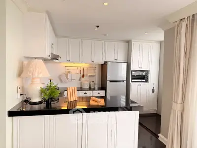 Charming kitchen with sleek black countertops and modern appliances in a cozy open layout