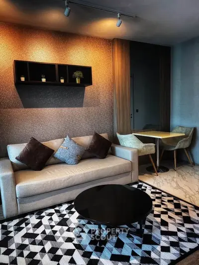 Modern living room with stylish sofa, geometric rug, and elegant dining area