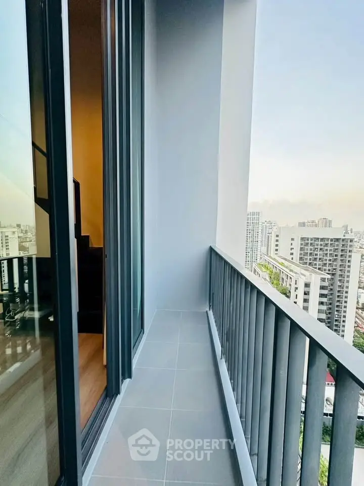 Modern high-rise balcony with stunning cityscape views and sleek railing design.