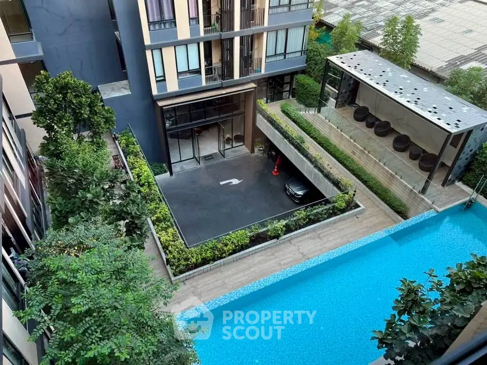 Modern condominium with pool view and lush greenery, featuring sleek architecture and inviting outdoor spaces.