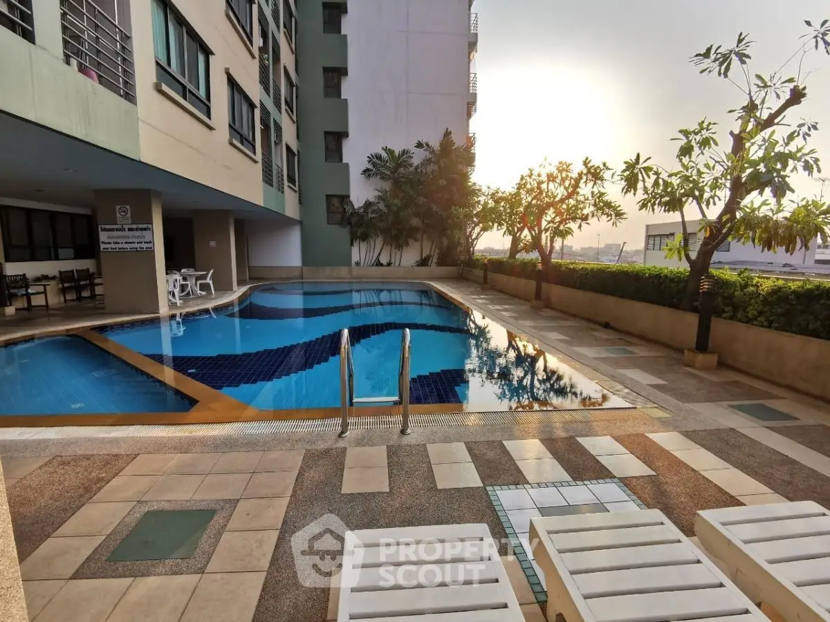 Luxurious apartment pool area with sunset view and lush greenery