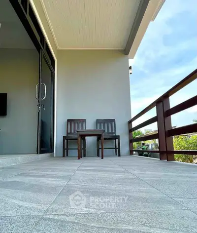 Spacious balcony with modern furniture and scenic view, perfect for relaxation and outdoor enjoyment.