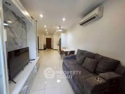 Spacious living room with modern decor and comfortable seating in a stylish apartment.