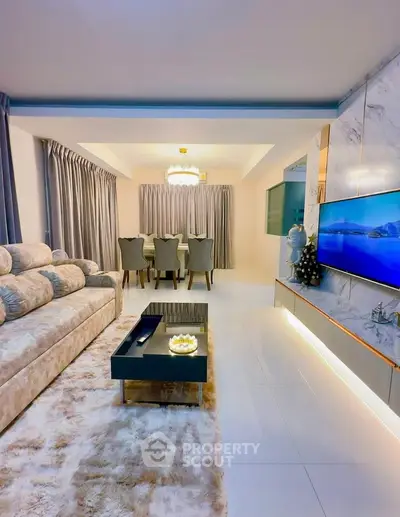 Luxurious living room with plush sofa, elegant dining area, and modern decor in a stylish open layout.