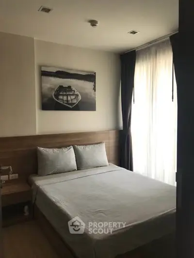 Cozy bedroom with natural light and modern decor in a stylish apartment.
