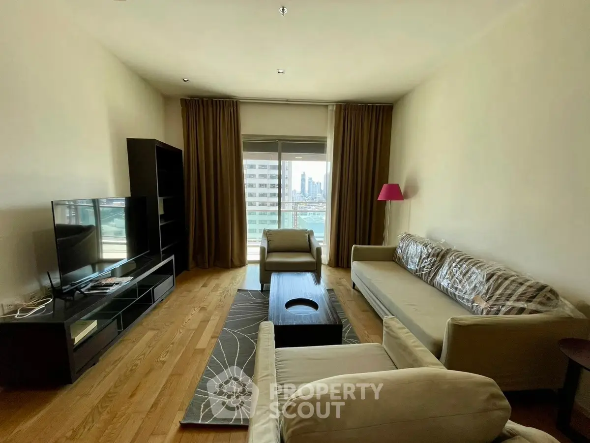 Spacious living room with modern furniture and city view, ideal for urban living.