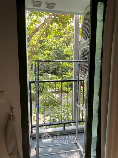 Charming balcony with lush green view, perfect for relaxation and enjoying nature.
