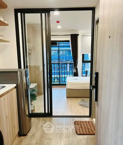 Modern studio apartment with open layout and balcony view