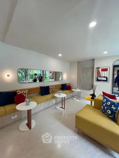 Modern living room with stylish decor and vibrant cushions in a cozy seating area.