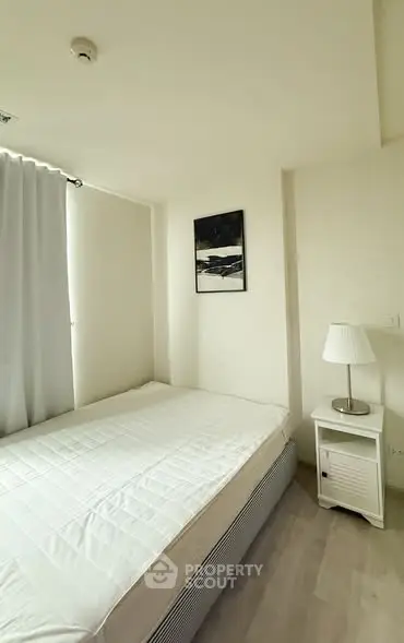 Cozy minimalist bedroom with natural light and modern decor