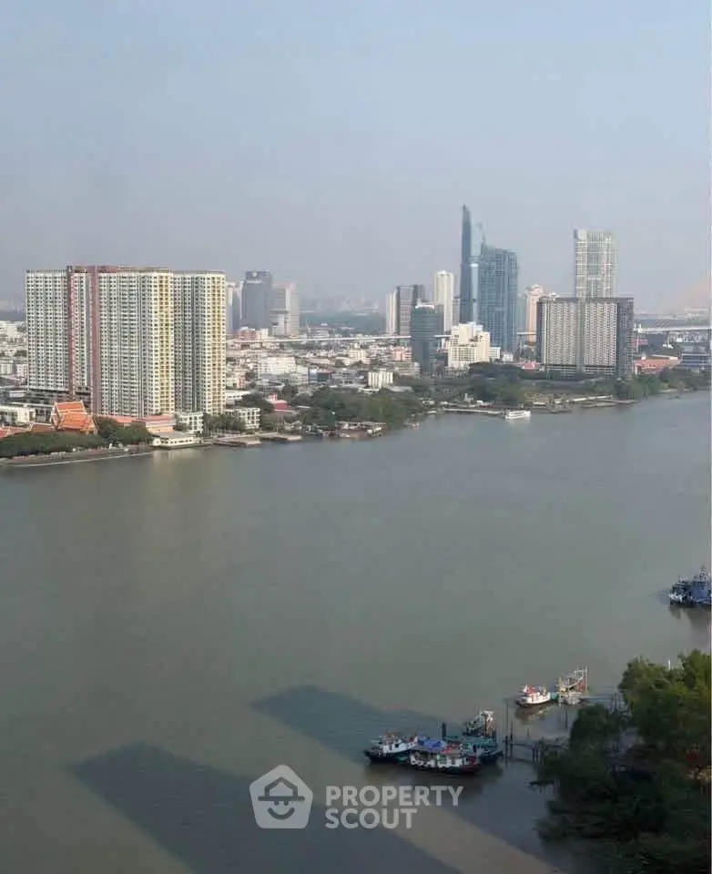 Stunning riverfront cityscape with modern high-rise buildings and serene water views.
