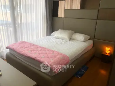 Cozy bedroom with modern design and soft lighting, featuring a plush bed and elegant decor.