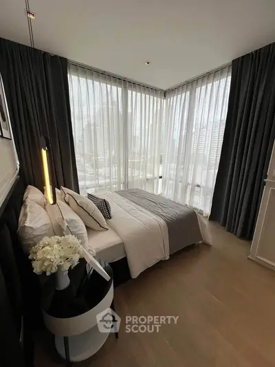 Luxurious corner bedroom with floor-to-ceiling windows and elegant decor