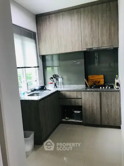 Modern kitchen with sleek cabinetry and gas stove in a compact layout