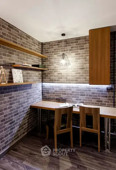 Stylish study room with brick walls and modern wooden furniture