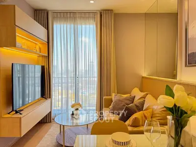 Stylish modern living room with large TV, cozy sofa, and elegant decor in a bright apartment.