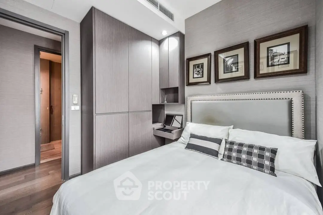 Modern bedroom with stylish decor and built-in storage in a luxury apartment.
