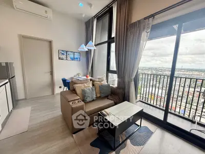 Modern living room with large windows and balcony offering stunning city views