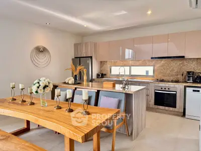 Luxurious open-layout kitchen with modern appliances and elegant dining area, perfect for entertaining.